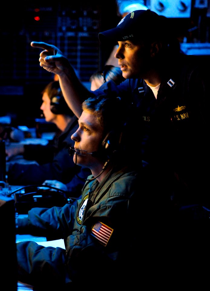 US Navy 090619-N-5345W-107 Lt. Christopher Barnes, right, anti-terrorism officer aboard the amphibious dock landing ship USS Fort McHenry (LSD 43), trains Lt.j.g. Ethan Blankenship on the next course of action as an anti-terror