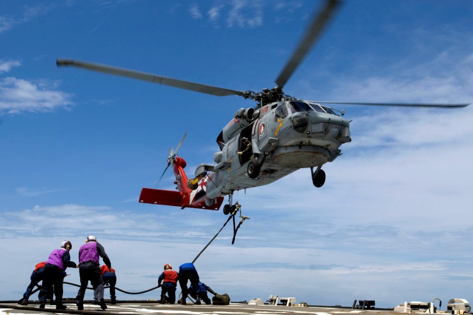 US Navy 090617-N-9123L-048 Sailors aboard the guided-missile destroyer USS McCampbell (DDG 85) send a fuel line to an SH-60B Sea Hawk helicopter during a helicopter in-flight refueling exercise