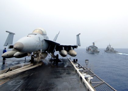 US Navy 090622-N-6720T-006 The aircraft carrier USS George Washington (CVN 73) approaches the Military Sealift Command fleet replenishment oiler USNS Pecos (T-AO 197) while the guided-missile cruiser USS Cowpens (CG 63) perform