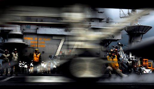 US Navy 090623-N-7780S-061 Lt. Cmdr. Everett Alcorn, from Manassas, Va., signals a launch as an F-A-18F Super Hornet from the Black Knights of Strike Fighter Squadron (VFA) 154 is catapulted from the aircraft carrier USS John C