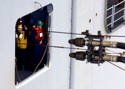 US Navy 090621-N-5253W-024 Sailors aboard the amphibious assault ship USS Essex (LHD 2) receive fuel lines from the Military Sealift Command fleet replenishment oiler USNS John Ericsson (T-AO 194)