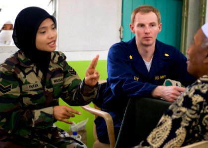 US Navy 090624-N-1722M-401 U.S. Navy doctor Lt. Cmdr. Scott Bannan and Malaysian Army Cpl. Intan Badri screen a patient during a Cooperation Afloat Readiness and Training (CARAT) Malaysia 2009 medical civil action project photo