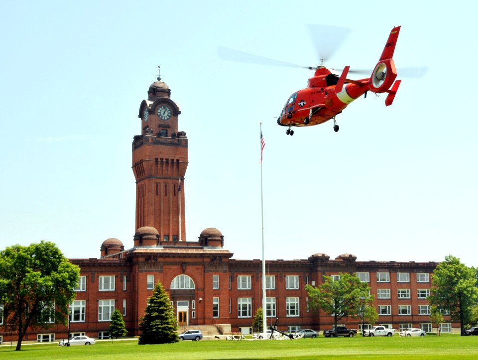 US Navy 090622-N-8848T-188 An HH-65C Dolphin helicopter from U.S. Coast Guard Air Station Traverse City, Mich., takes off from historic Ross Field in front of headquarters Building 1 at Naval Station Great Lakes