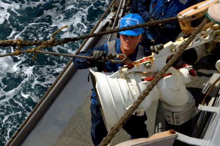 US Navy 090619-N-9123L-040 Boatswain's Mate 3rd Class Brett Butler, from Tallahassee, Fla., attaches span wire to a fuel probe aboard the guided-missile destroyer USS McCampbell (DDG 85) during an underway replenishment