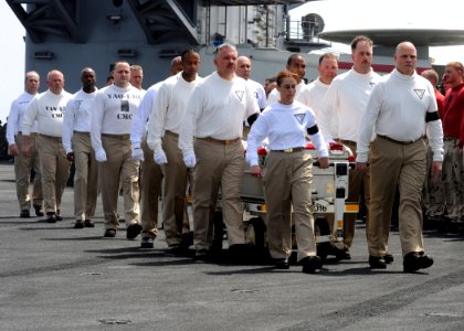 US Navy 090622-N-9988F-004 Chief petty officers assigned to Carrier Air Wing (CVW) 7 carry the casket of Command Master Chief Jeffrey J. Garber during a departure ceremony aboard the aircraft carrier USS Dwight D. Eisenhower (C