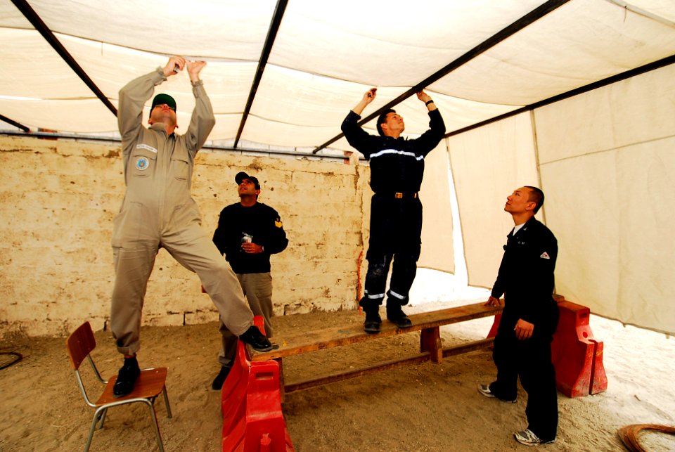 US Navy 090622-N-7092S-262 Multinational sailors set up a tarp roof at the Jardin Infantil Jesus de Puaga day care center during a Southern Seas 2009 community service project