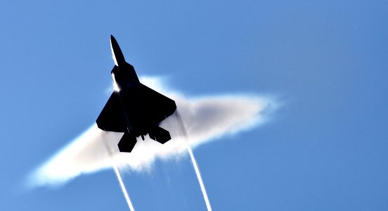 US Navy 090622-N-8290D-008 An Air Force F-22 Raptor executes a supersonic flyby over the flight deck of the aircraft carrier USS John C. Stennis (CVN 74)