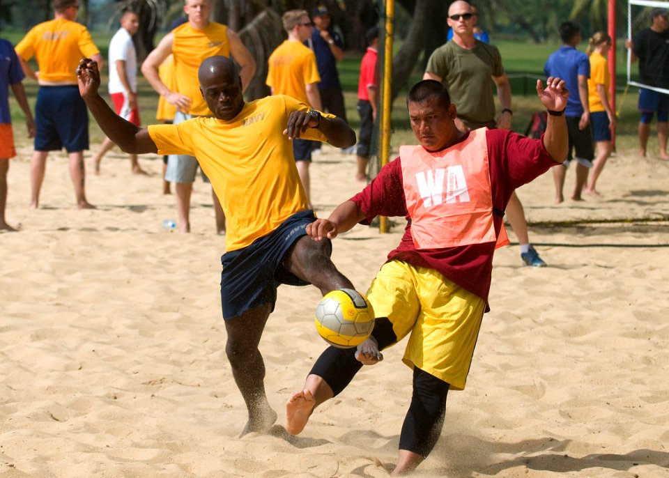 US Navy 090625-N-1722M-159 Aviation Structural Mechanic 2nd Class Craig White, assigned to the dock landing ship USS Harpers Ferry (LSD 49), battles for possession against Malaysian Army Lance Cpl. Mohd Samsul during a game of