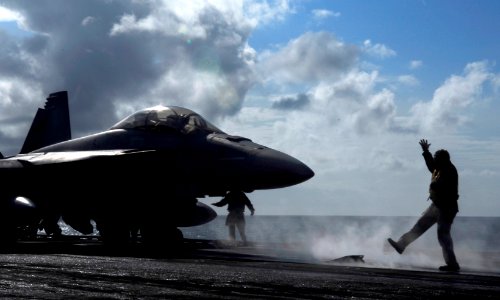 US Navy 090622-N-7780S-067 Senior Chief Aviation Boatswain's Mate (Handling) Wilson Theodore, from New Orleans, signals that an F-A-18C Hornet, from the Death Rattlers of Marine Strike Fighter Squadron (VMFA) 323, is on the cat