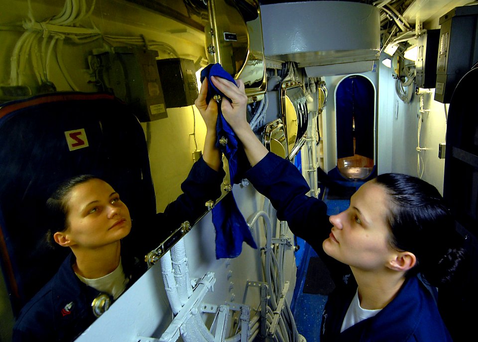 US Navy 090623-N-6720T-033 Operations Specialist 2nd Class Kimberly Buchanan polishes bright work during cleaning stations aboard the aircraft carrier USS George Washington (CVN 73)