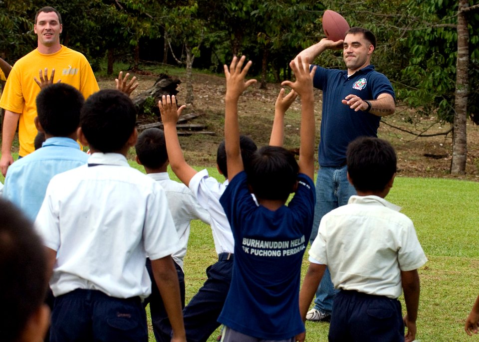 US Navy 090624-N-1722M-460 Cpl. Joshua Coldiron, assigned to the 24th Marine Regiment, throws a pass during a game of American football with Malaysian students