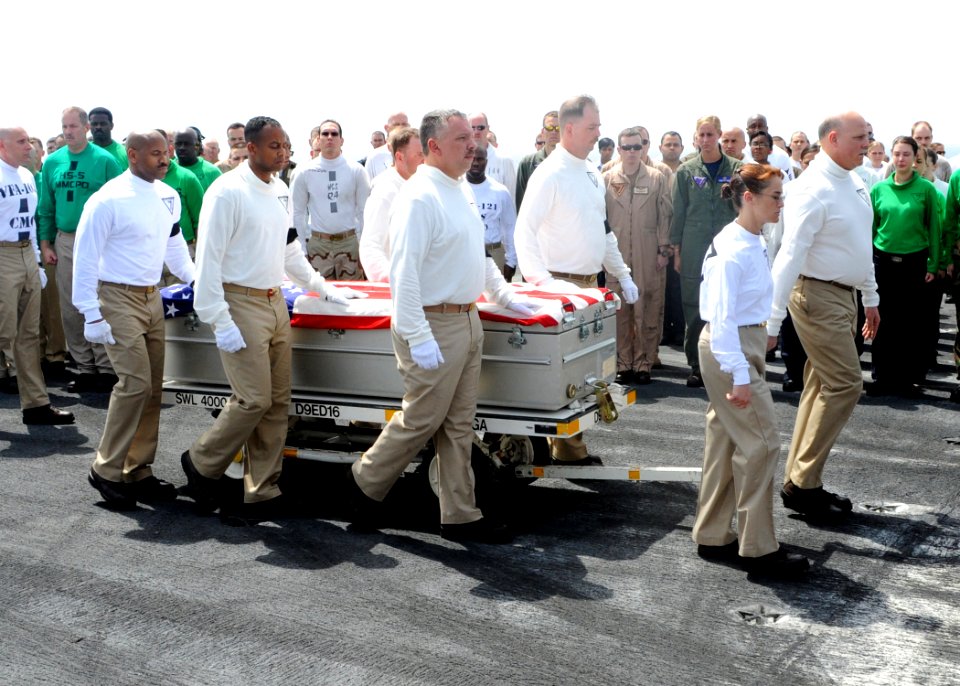 US Navy 090622-N-9988F-002 Chief petty officers assigned to Carrier Air Wing (CVW) 7 carry the casket of Command Master Chief Jeffrey J. Garber during a departure ceremony aboard the aircraft carrier USS Dwight D. Eisenhower (C