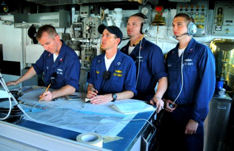 US Navy 090626-N-4774B-036 Navigation officer Lt. Michael Hurban, center, digitally charts a course on the bridge of the guided-missile cruiser USS Lake Champlain (CG 57)