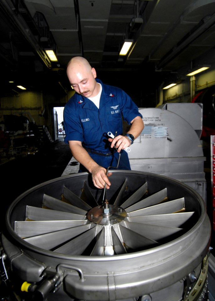 US Navy 090622-N-6720T-023 Aviation Machinists Mate 2nd Class Shaun Elling, assigned to the jet engine shop in the aviation intermediate maintenance department, performs maintenance on an F-A-18E Super Hornet engine