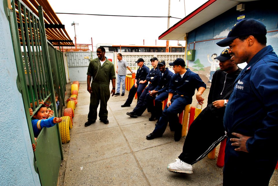 US Navy 090622-N-7092S-574 Sailors assigned to the guided-missile frigate USS Kauffman (FFG 59) entertain children from the Jardin Infantil Jesus de Puaga day care center during a Southern Seas 2009 community service project