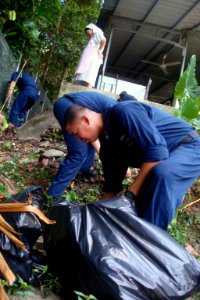 US Navy 090626-N-5586R-098 Sailors assigned to the aircraft carrier USS Ronald Reagan (CVN 76) pick weeds and rake leaves at the Franciscan Missionaries of Mary, House of Prayer and Formation during a community relations (COMRE