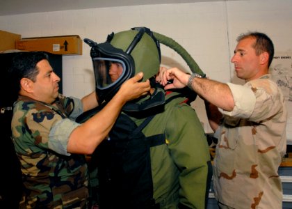 US Navy 090624-N-4649C-004 Sailors don an explosive ordnance disposal suit during explosive handling training at U.S. Coast Guard Station Quillayute River, Wash