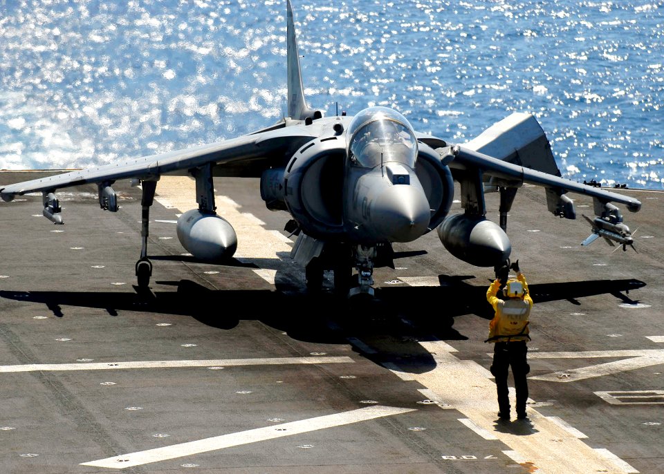 US Navy 090625-N-9950J-215 Aviation Boatswain's Mate (Handling) 3rd Class Steven Viles, from Chicago, stages an AV-8B Harrier for take off from amphibious assault ship USS Essex (LHD 2)