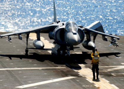 US Navy 090625-N-9950J-215 Aviation Boatswain's Mate (Handling) 3rd Class Steven Viles, from Chicago, stages an AV-8B Harrier for take off from amphibious assault ship USS Essex (LHD 2)