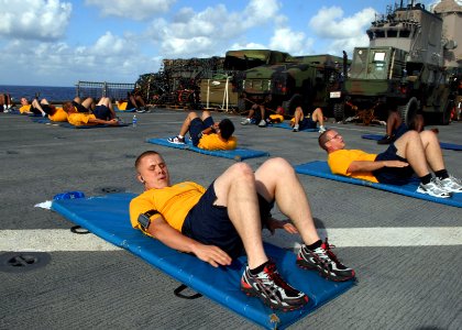 US Navy 090710-N-6692A-037 Sailors exercise during routine physical fitness training aboard the amphibious dock landing ship USS Tortuga (LSD 46) photo