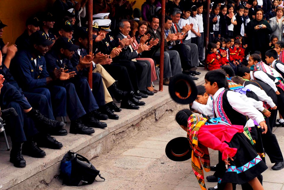 US Navy 090710-N-7092S-491 Students from Escuela General Basica Centenario take a bow to Sailors from guided-missile frigate USS Kauffman (FFG 59) after performing a native folk dance during a community relations project in Ari