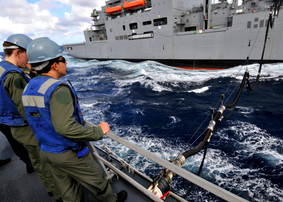 US Navy 090708-N-2638R-002 Midshipmen from the Royal Australian Navy aboard the Arleigh Burke-class guided-missile destroyer USS Mustin (DDG 89) watch the Military Sealift Command dry cargo-ammunition ship USNS Amelia Earhart (
