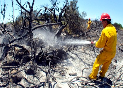 US Navy 090711-N-0780F-004 Naval Support Activity, Souda Bay civilian firefighters mop up the remnants of a brush fire near the village of Pazinos in western Crete