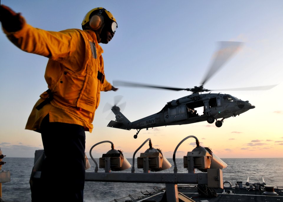US Navy 090710-N-4236E-346 Boatswain's Mate 2nd Class Michael Trapps directs an MH-60S Sea Hawk helicopter from Helicopter Sea Combat Squadron (HSC) 22 during deck landing qualifications