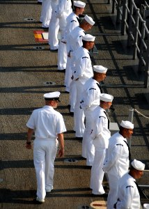 US Navy 090710-N-0860R-016 Chief Aviation Boatswain's Mate - Handling (AW-SW) Wade Keller walks behind Sailors from USS Makin Island's (LHD 8) AIMD and Air departments man the rails