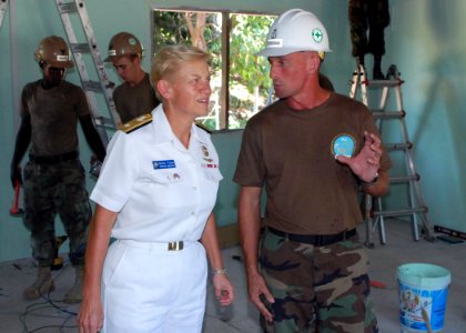 US Navy 090710-N-5207L-494 Chief Builder Eric Johnson of Naval Mobile Construction Battalion (NMCB) 40 updates Rear Adm. Nora Tyson, Commander, Logistics Group Western Pacific, on a new multi-use room being built at Ban Khao By photo