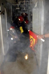 US Navy 090710-A-8397T-008 Sailors aboard the amphibious dock landing ship USS Oak Hill (LSD 51) simulate fighting a fire during a fire drill