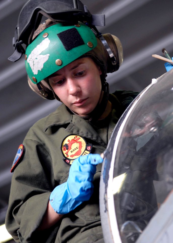 US Navy 090711-N-9520G-062 Cpl. Miranda Bouska of San Antonio, Texas, assigned to Fixed Wing Marine Attack Squadron (VMA -211) and embarked aboard the amphibious assault ship USS Essex (LHD 2) applies sealant on the cockpit of
