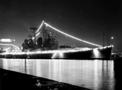 USS Boston (CAG-1) illuminated at Naples, in October 1964 (NH 98293)