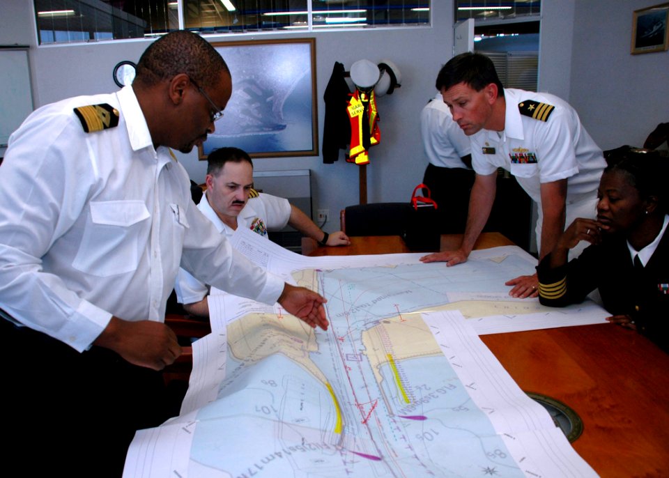 US Navy 090713-N-1655H-129 Durban Harbour Master Rufus Lekala, left, discusses the layout of local channels with Capt. Jim Tranoris
