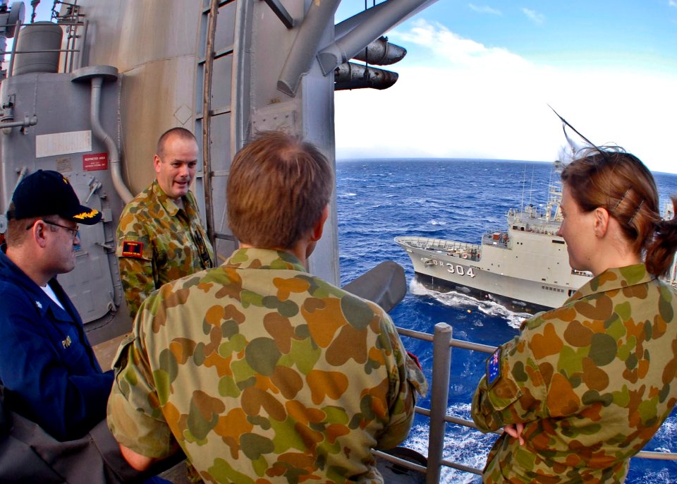 US Navy 090711-N-9950J-268 Cmdr. Michael Picio talks with a group of Australian Navy officers aboard the forward-deployed amphibious assault ship USS Essex (LHD 2) during an underway replenishment with the Australian underway r