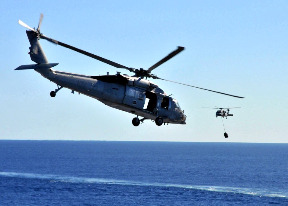 US Navy 090711-N-1644H-063 An MH-60S Sea Hawk helicopter from the Island Knights of Helicopter Combat Squadron (HSC) 25 during a vertical replenishment with Military Sealift Command dry cargo-ammunition ship USNS Alan Shepard (