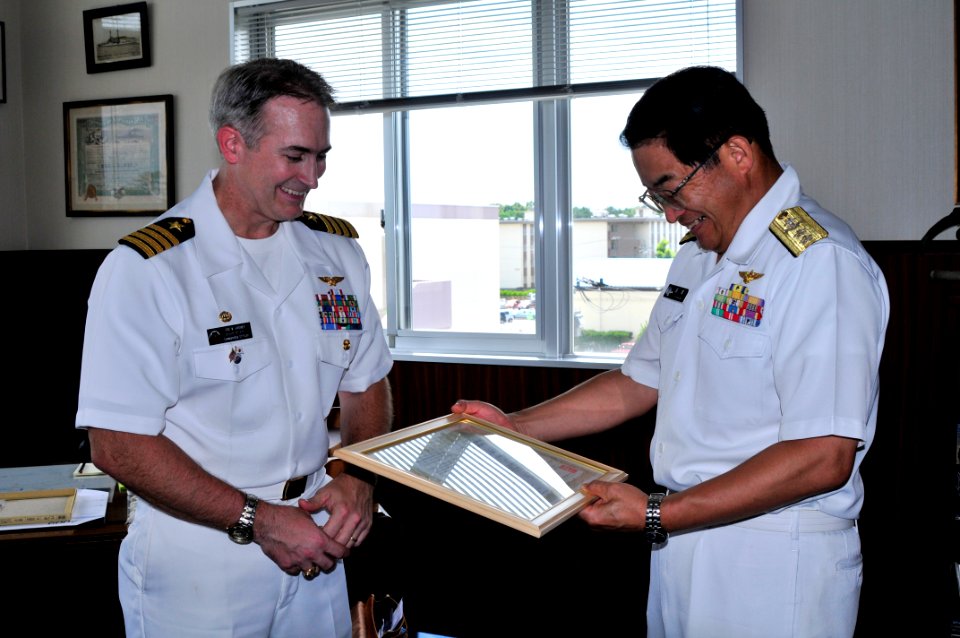 US Navy 090713-N-4031K-002 Capt. Eric Gardner, commanding officer of Naval Air Facility Atsugi, presents Rear Adm. Kazuo Takahashi with a certificate of appreciation