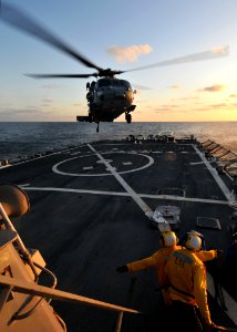 US Navy 090710-N-4236E-186 Boatswain's Mate 2nd Class Michael Trapps and Boatswain's Mate 2nd Class Jason Goedhart direct an MH-60S Sea Hawk helicopter from Helicopter Sea Combat Squadron (HSC) 22 during deck landing qualificat