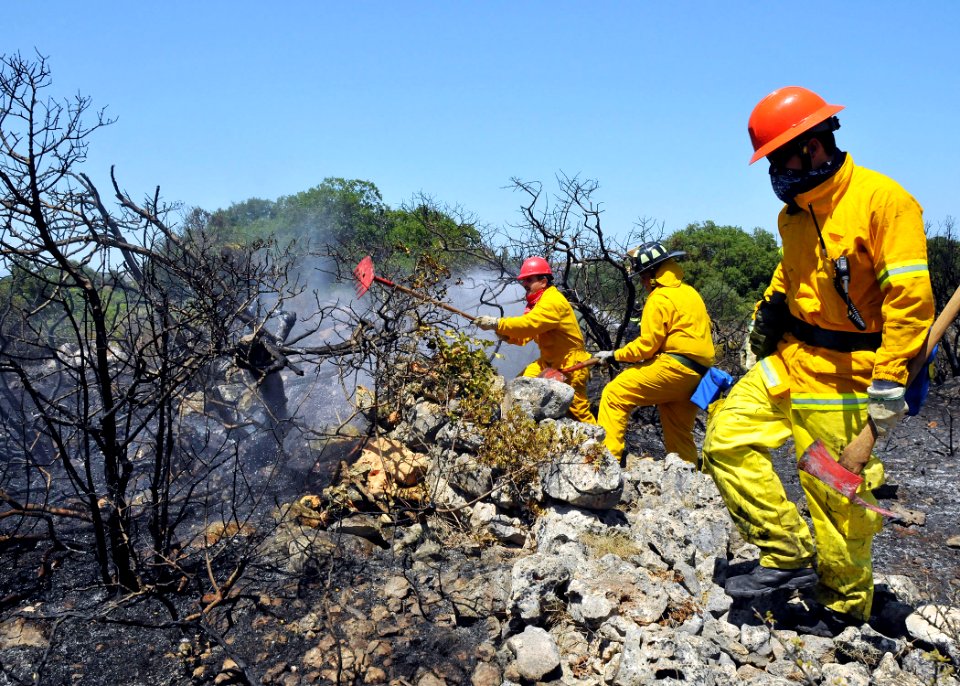 US Navy 090711-N-0780F-003 Naval Support Activity, Souda Bay civilian firefighters mop up the remnants of a brush fire near the village of Pazinos in western Crete