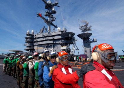 US Navy 090712-N-6720T-034 The aircraft carrier USS George Washington (CVN 73) and Carrier Air Wing (CVW) 5 Sailors wait in line to relieve hose team members during a mass casualty drill on the flight deck