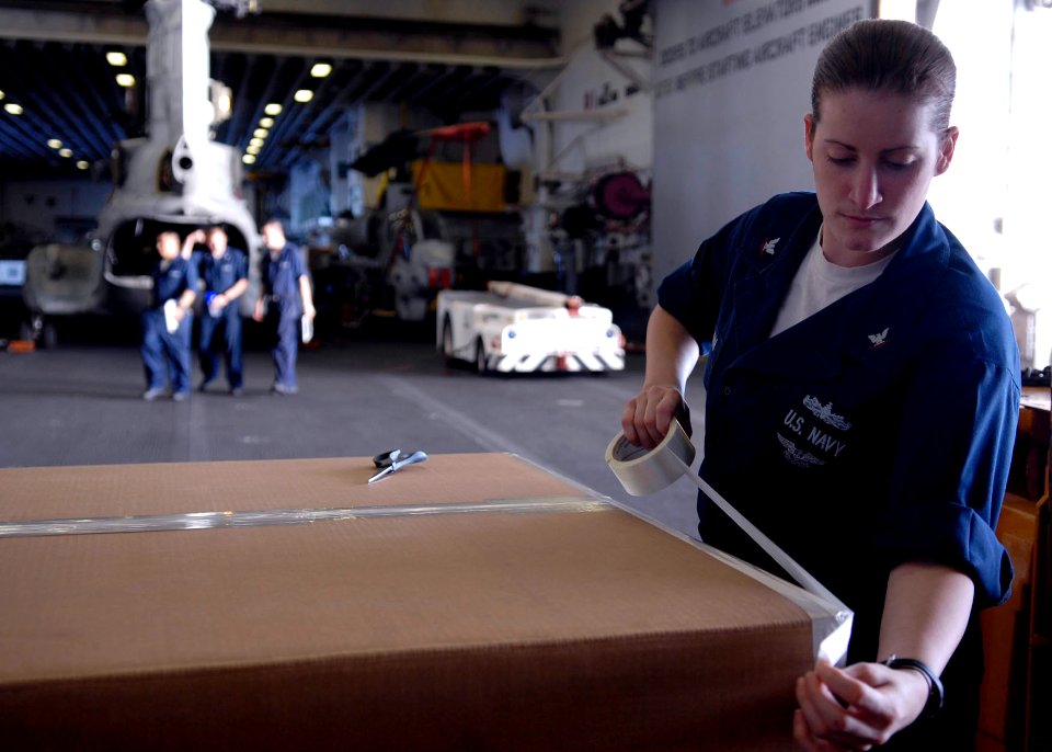 US Navy 090711-N-9520G-017 torekeeper 3rd Class Rosanna Jordan of Roseville, Calif., assigned to amphibious assault ship USS Essex (LHD 2) secures boxes for shipment in the ship's hanger bay
