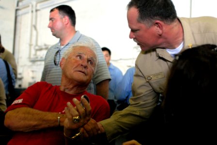 US Navy 090713-N-9132C-155 Former NFL Head Coach Don Shula receives a coin from Lt. Cmdr. Len Bunch in the hangar bay of the aircraft carrier USS Ronald Reagan (CVN 76)
