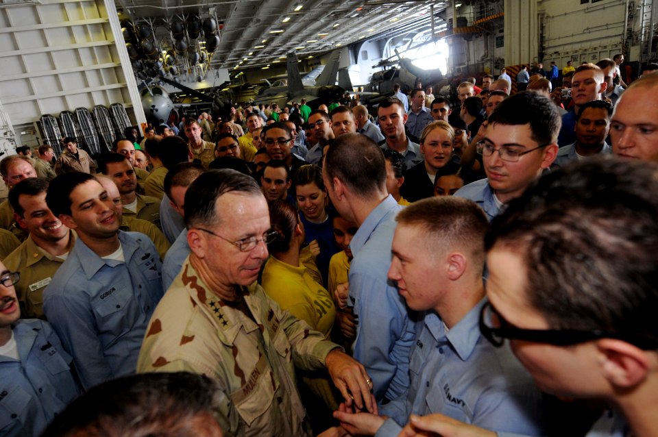 US Navy 090713-N-3659B-263 Adm. Mike Mullen, chairman, Joint Chiefs of Staff, hands out his coin to Sailors aboard the aircraft carrier USS Ronald Reagan (CVN 76)