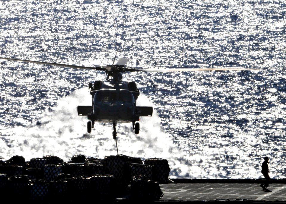 US Navy 090711-N-1644H-136 An MH-60S Sea Hawk helicopter from the Island Knights of Helicopter Combat Squadron (HSC) 25 during a vertical replenishment with Military Sealift Command dry cargo-ammunition ship USNS Alan Shepard (