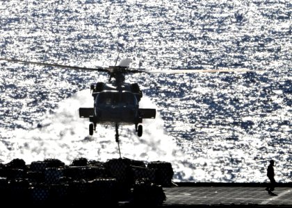 US Navy 090711-N-1644H-136 An MH-60S Sea Hawk helicopter from the Island Knights of Helicopter Combat Squadron (HSC) 25 during a vertical replenishment with Military Sealift Command dry cargo-ammunition ship USNS Alan Shepard (