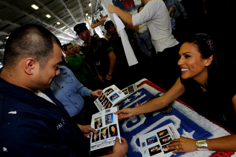 US Navy 090713-N-3659B-420 Television personality Leeann Tweeden gives an autograph to Aviation Support Equipment Technician Airman John Palacio during a USO Summer Troop Visit aboard the aircraft carrier USS Ronald Reagan (CVN