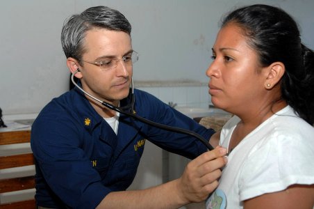 US Navy 090713-F-1333S-029 Lieutenant Commander Todd Gleeson, embarked aboard the Military Sealift Command hospital ship USNS Comfort (T-AH 20), provides medical care to a Nicaraguan woman