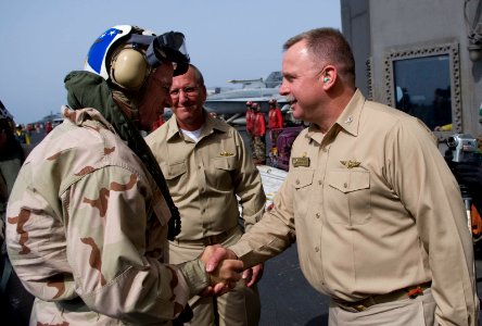 US Navy 090713-N-0696M-064 Adm. Mike Mullen, left, chairman of the Joint Chiefs of Staff, is greeted by Capt. Kenneth Norton, commanding officer of the aircraft carrier USS Ronald Reagan (CVN 76) in the Gulf of Oman photo