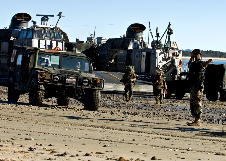 US Navy 090715-N-5253W-052 Seaman Nyja Allen, from New York assigned to Beachmaster Unit (BMU) 1, Detachment Western Pacific, directs the offload of U.S. Marines and vehicles