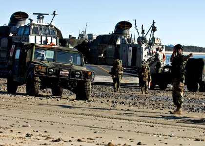 US Navy 090715-N-5253W-052 Seaman Nyja Allen, from New York assigned to Beachmaster Unit (BMU) 1, Detachment Western Pacific, directs the offload of U.S. Marines and vehicles